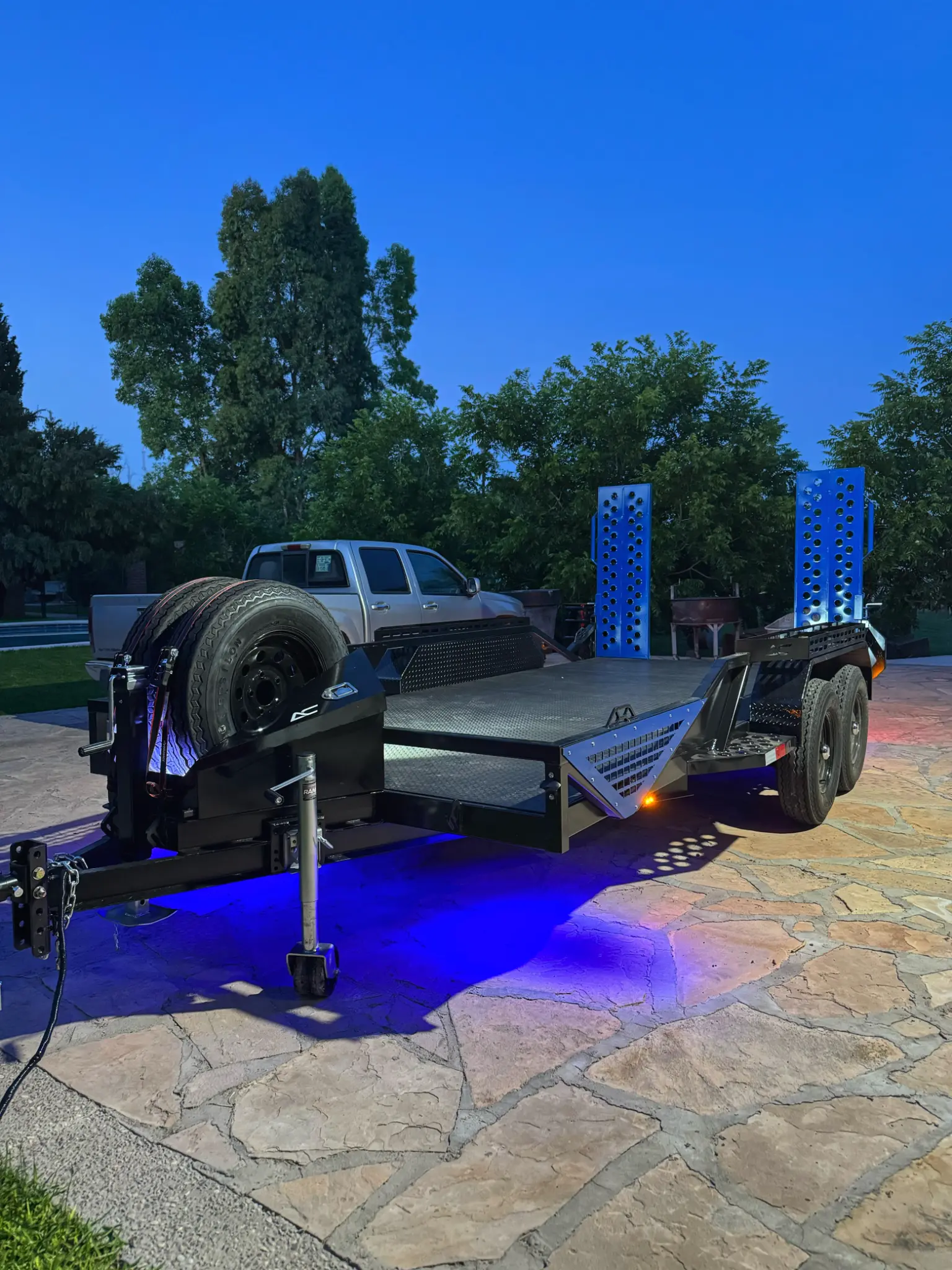 Custom equipment trailer with blue LED underglow lighting and spare tire mount - AC Solutions El Paso