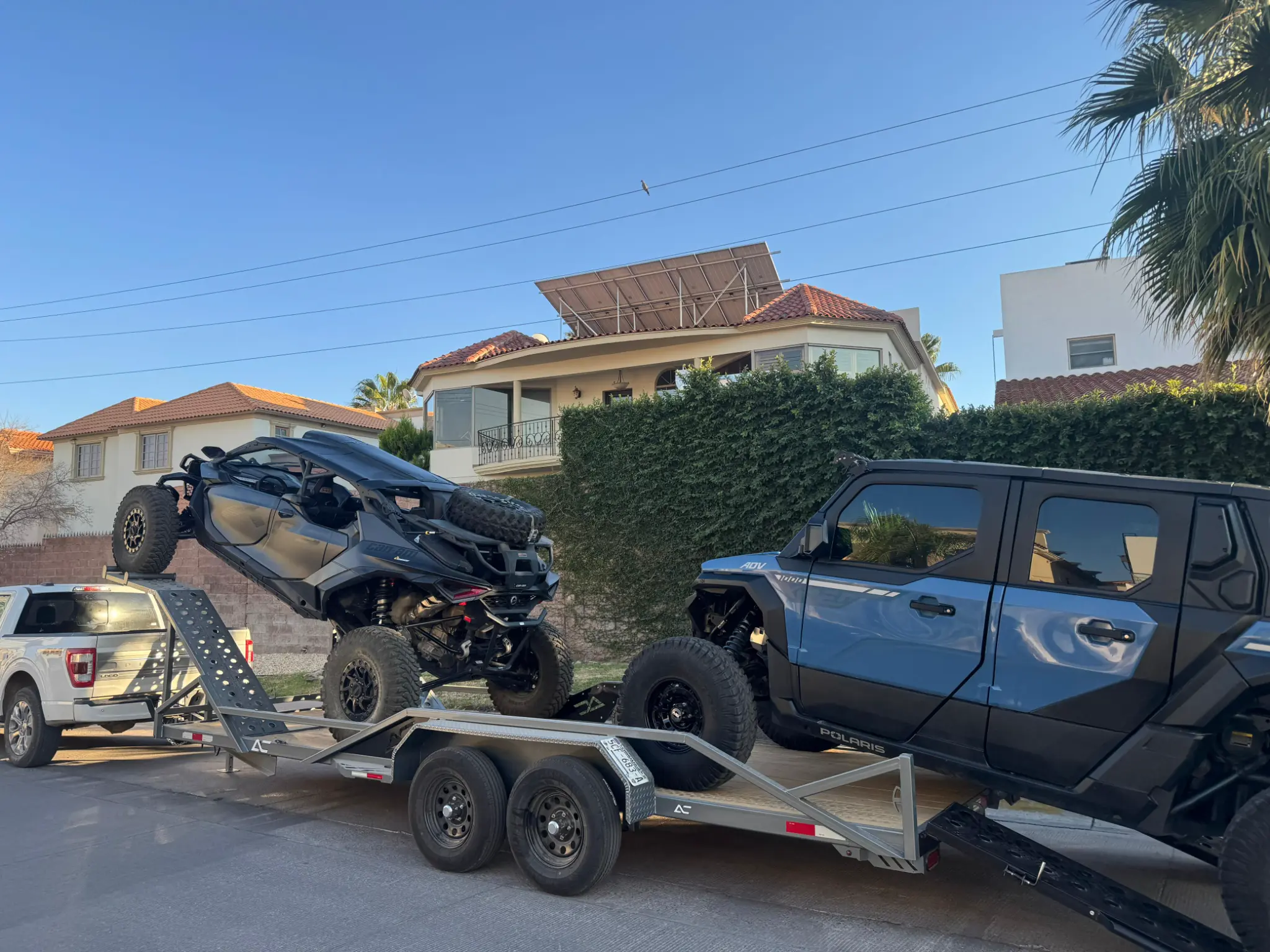 Heavy-duty custom equipment trailer hauling Polaris UTV with aluminum ramps - El Paso custom trailer manufacturing